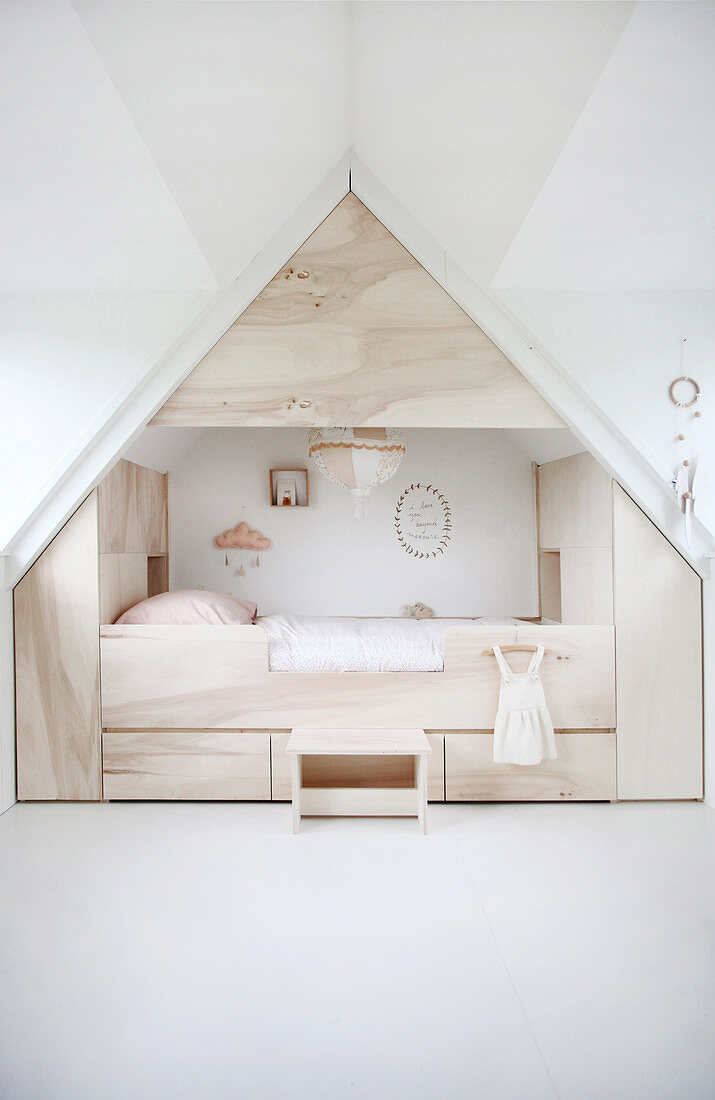 Modern cubby bed surrounded by storage in child's attic bedroom