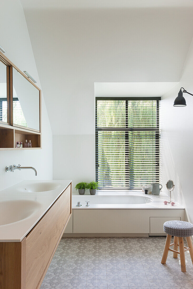 Bright bathroom with wooden washbasin and ornamental floor tiles