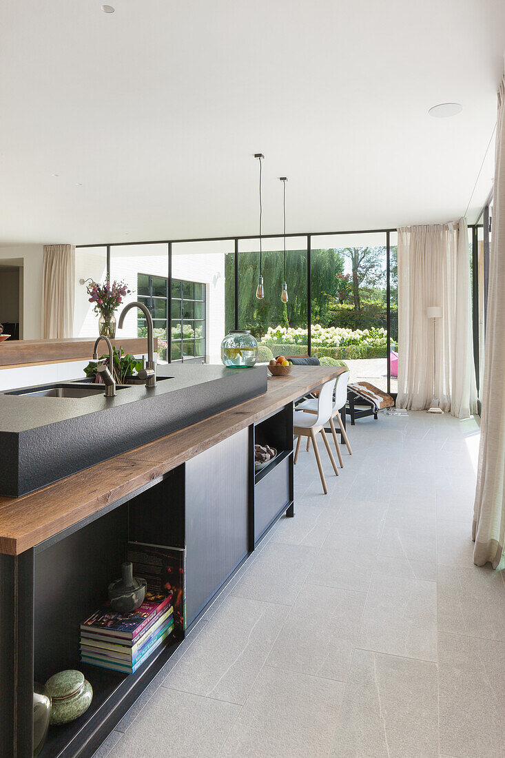 Modern kitchen with cooking island and view of the garden