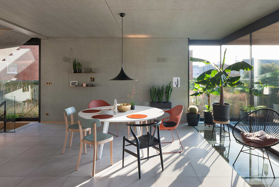 Dining table with various chairs in a bright dining room