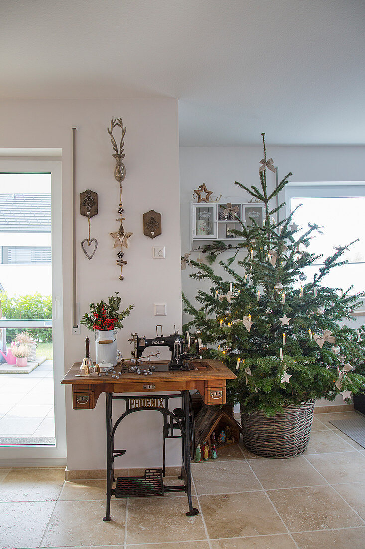 Sewing machine table and Christmas tree in basket in living room