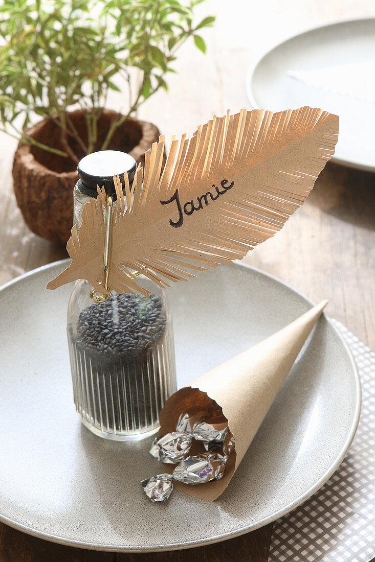 Table decoration with handmade paper feather as name tag