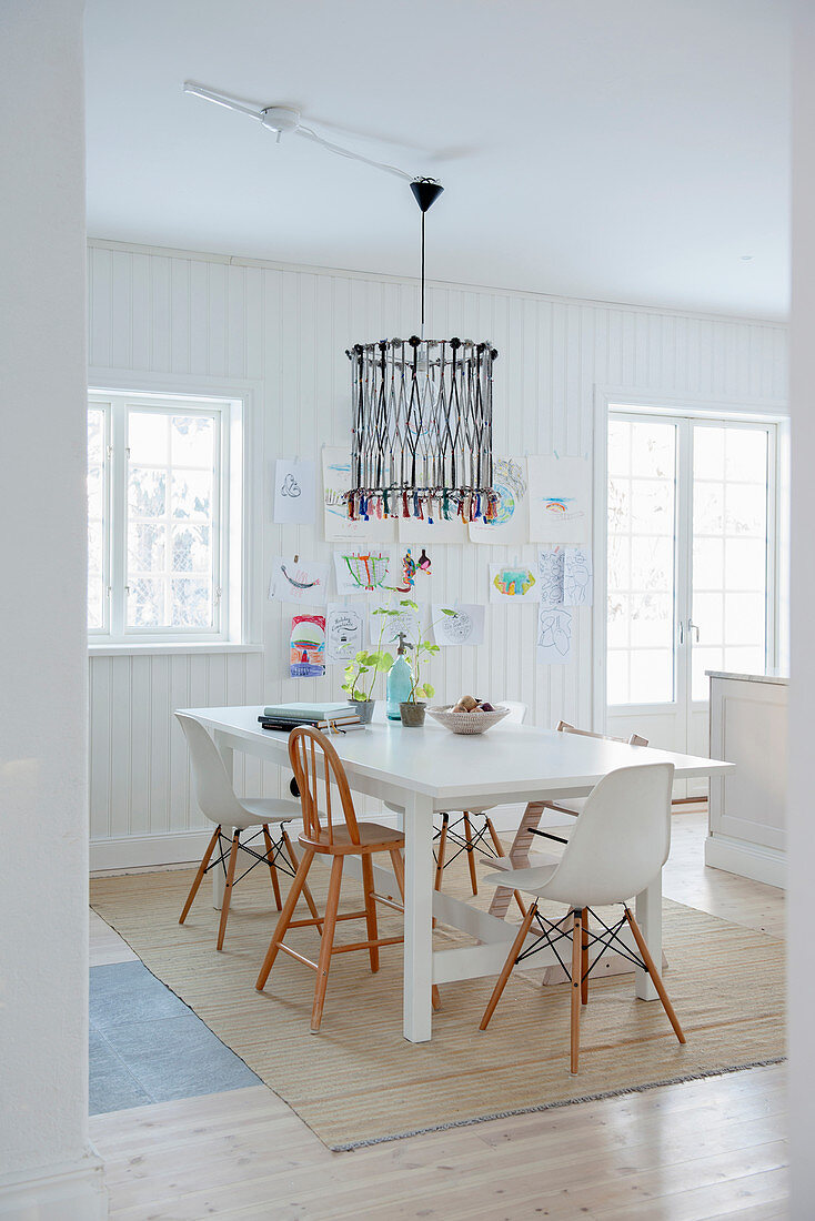 White shell chairs and highchairs around dining table