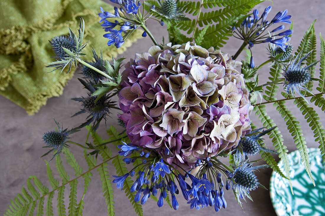 Bouquet of agapanthus, hydrangea, sea holly and fern leaves