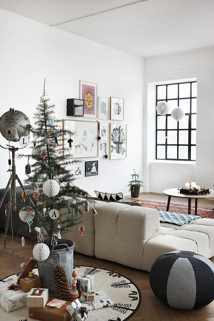 Small Christmas tree and gifts in vintage-style living room