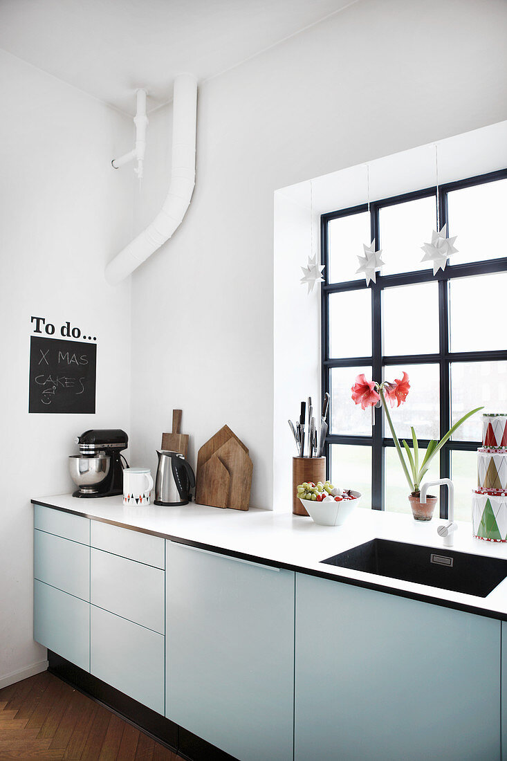 Modern kitchen with industrial-style window and festive decorations