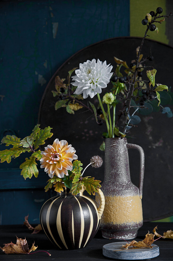 Autumn bouquets of of dahlias and branches of oak and sloes