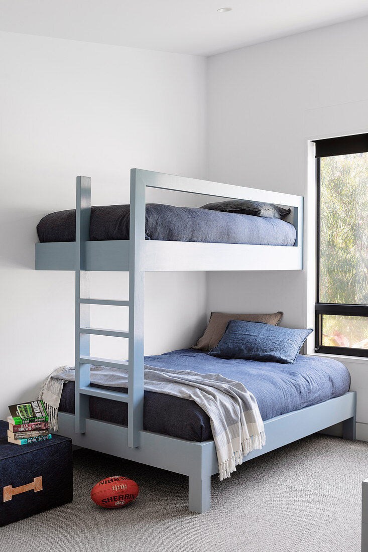 Modern bunk bed in light blue in the simple boys' bedroom