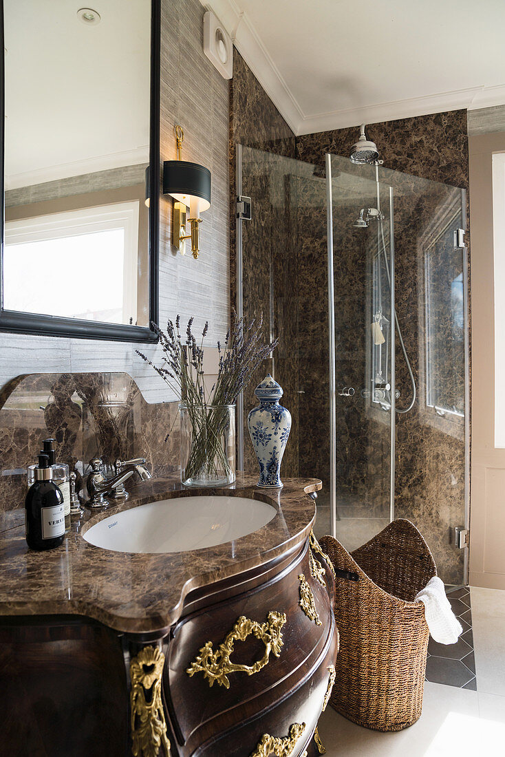 Opulent, Baroque washstand with stone top in classic bathroom
