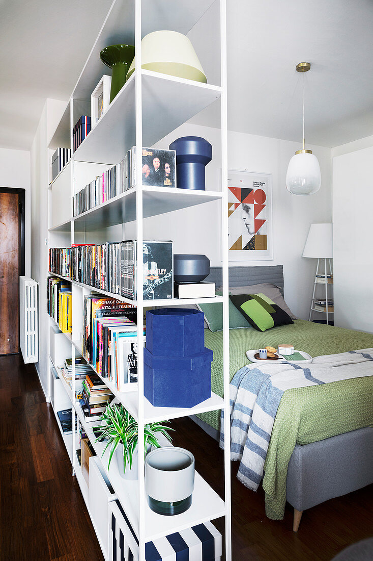 Partition shelving screening bed in small studio apartment