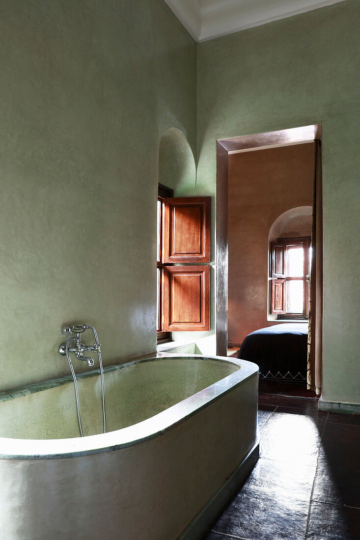 Gemauerte Badewanne im mediterranen Bad mit grünen Wänden