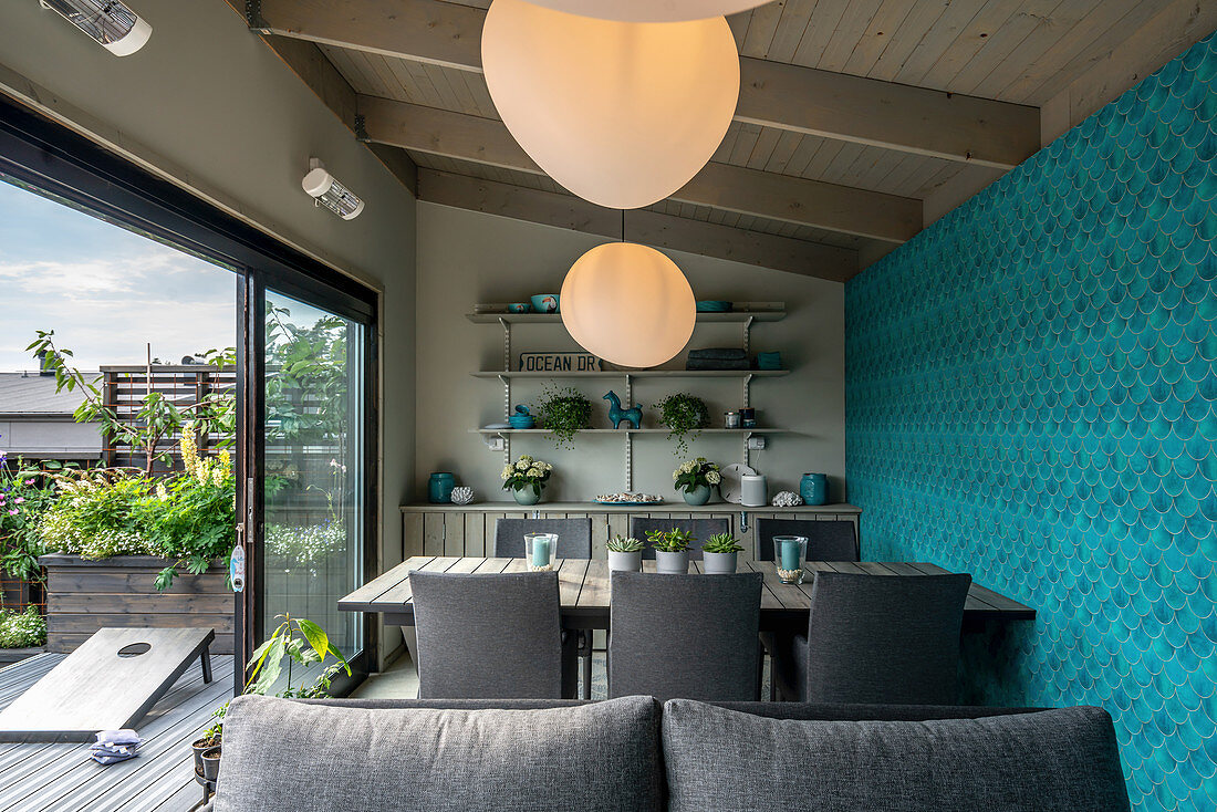 Modern dining room with blue wall in summerhouse