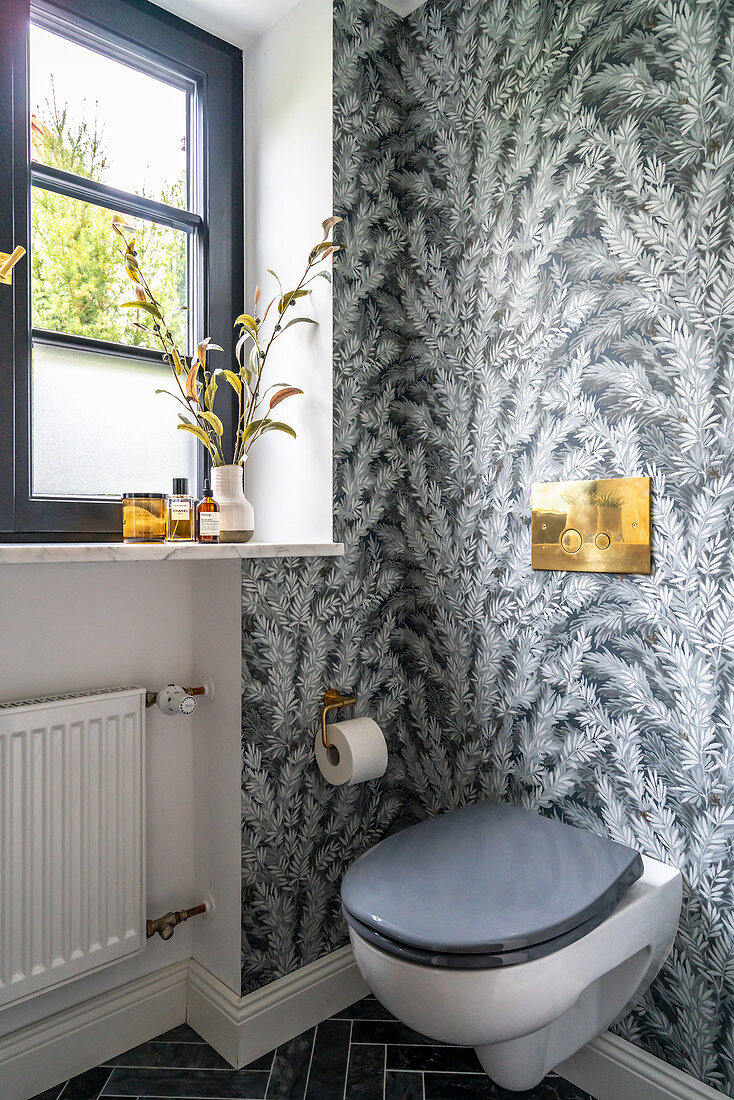 Toilet with window and grey patterned wallpaper