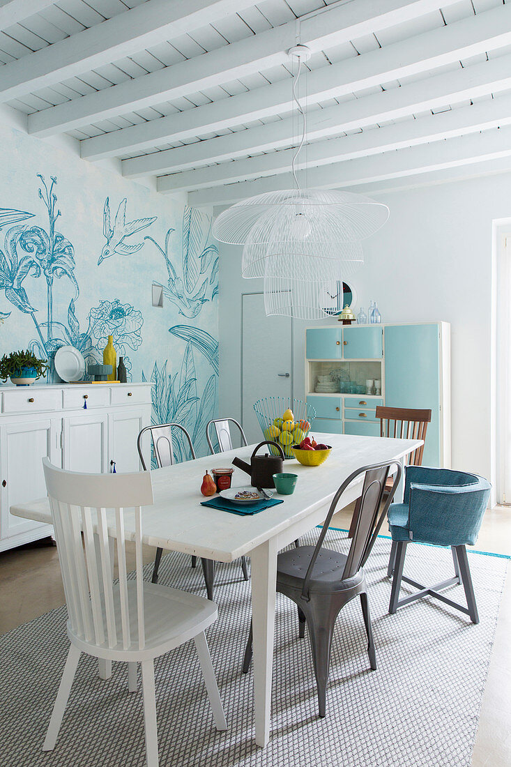Dining area in white country-house kitchen with blue-and-white wallpaper