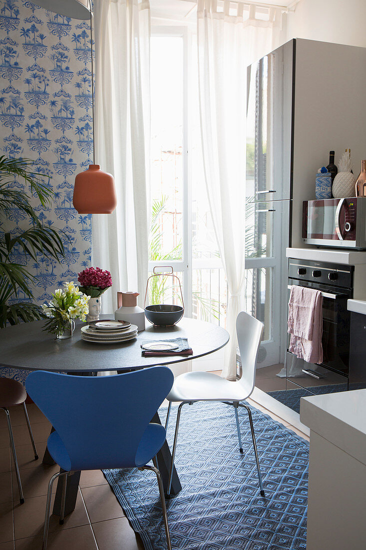 Round dining table in small, blue-and-white kitchen-dining room