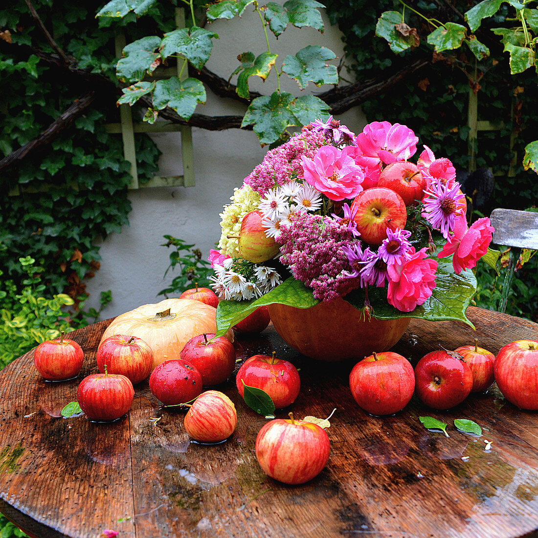 Autumn bouquet with apples and rose petals