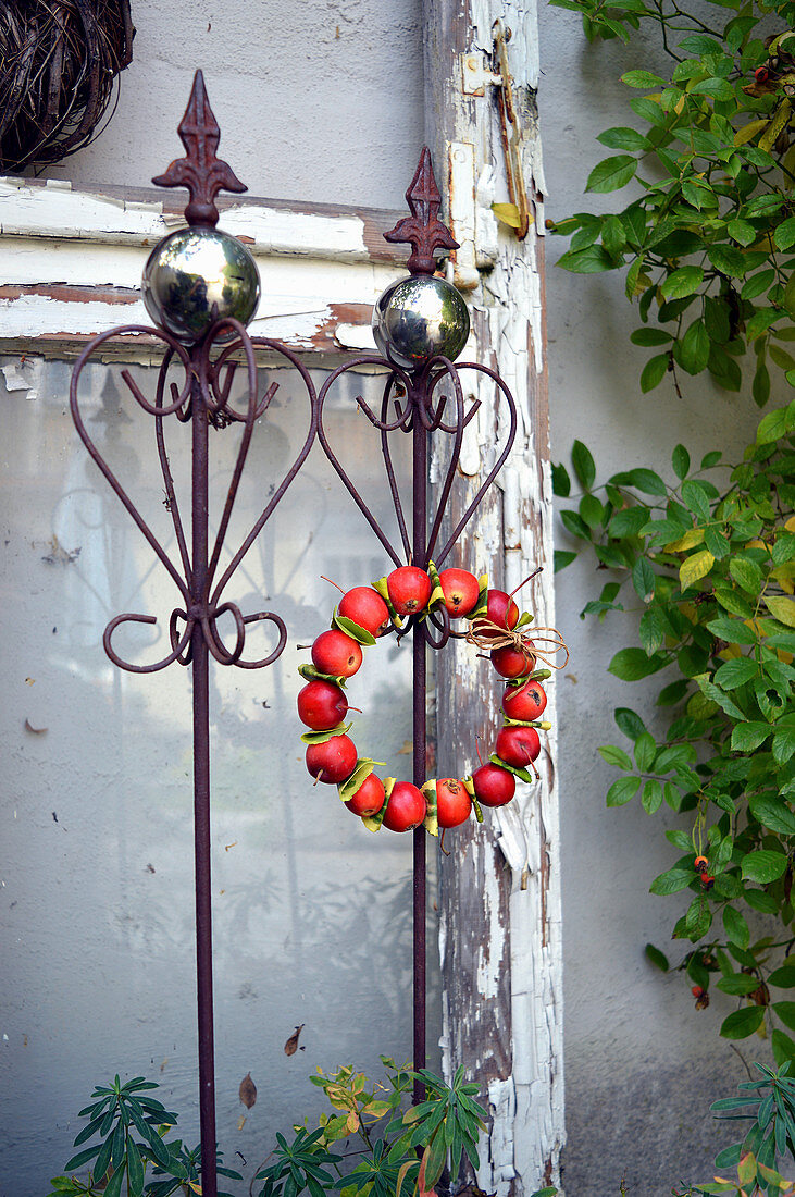 Wreath of ornamental apples on a decorative element