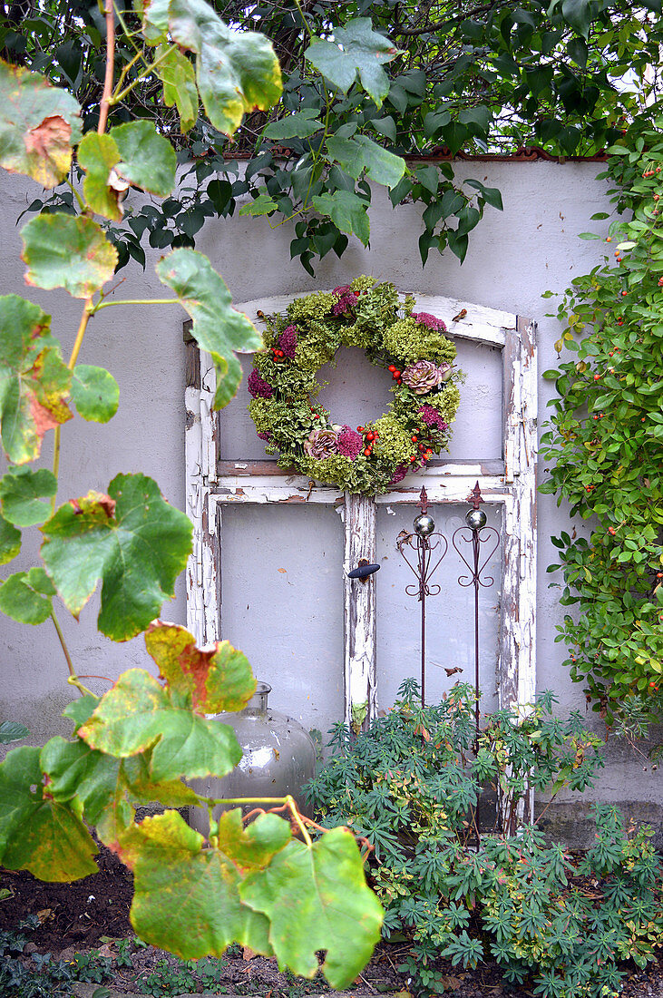 Autumn wreath on the old window frame