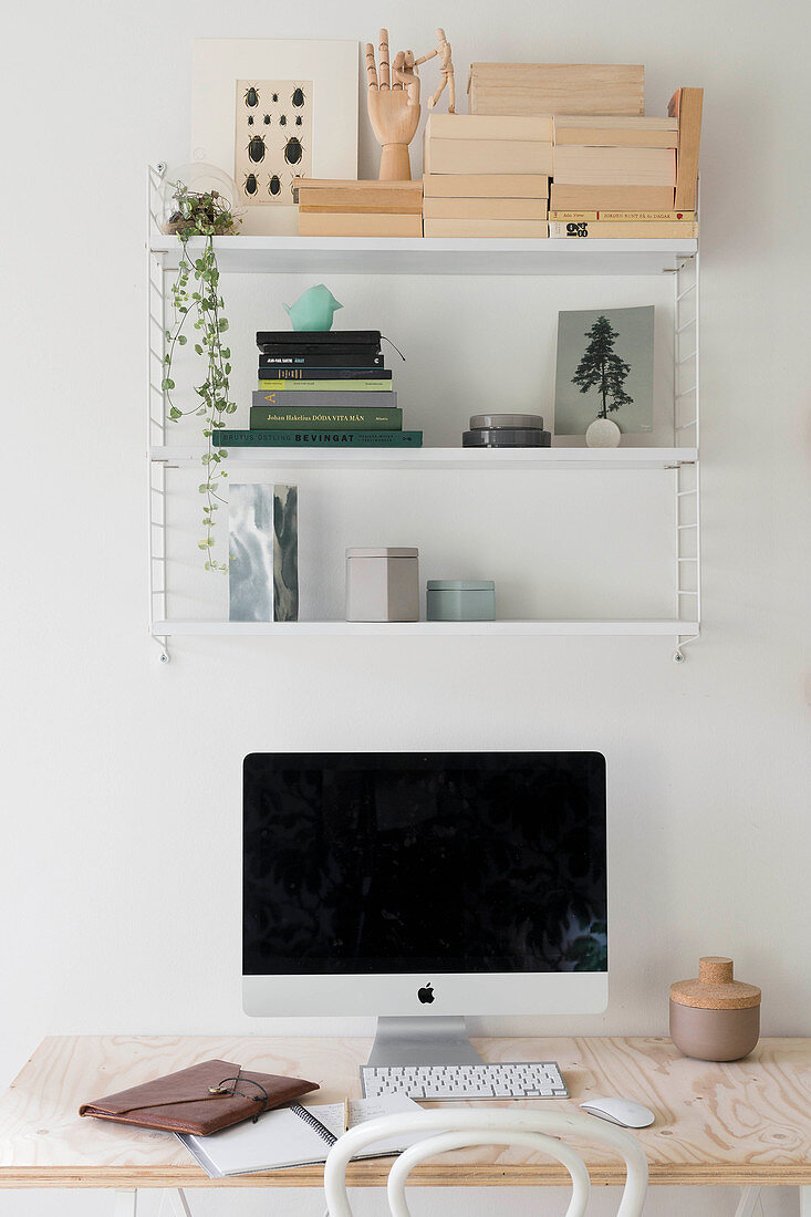 Classic String shelves above computer on plywood desk