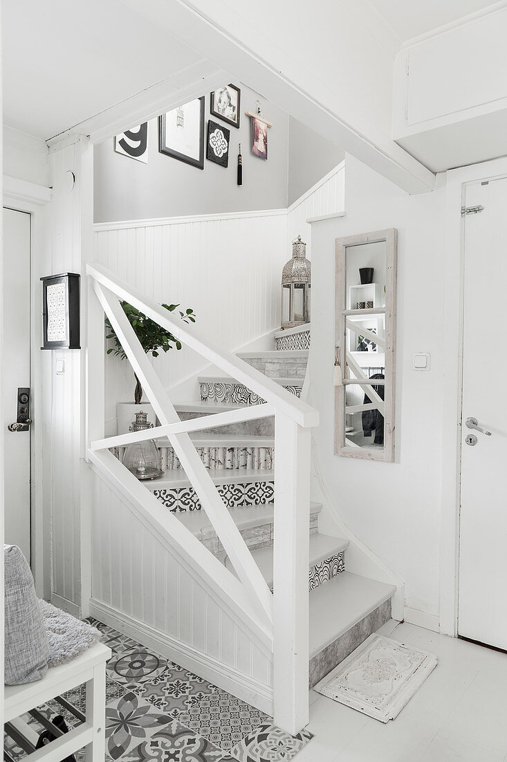 Staircase with variety of patterns on risers in monochrome foyer