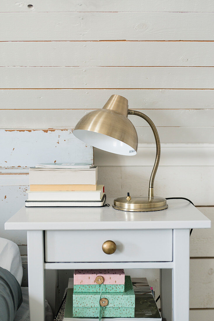 Silver vintage-style lamp on bedside table