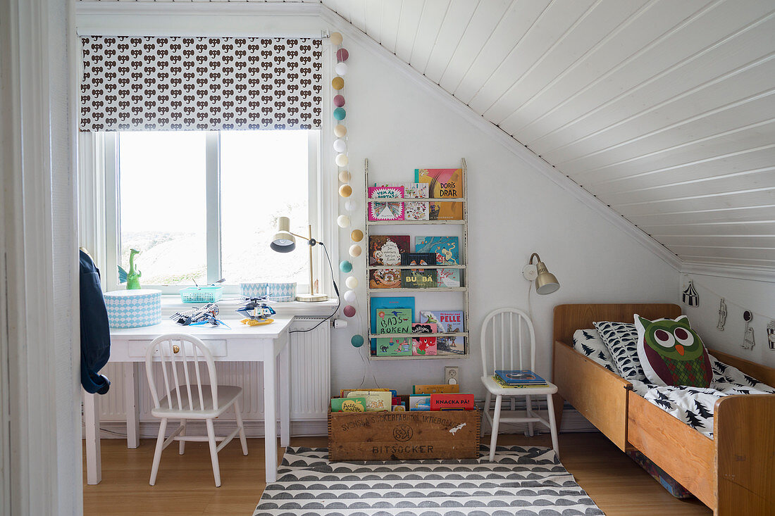 Extendable bed under sloping ceiling in child's bedroom