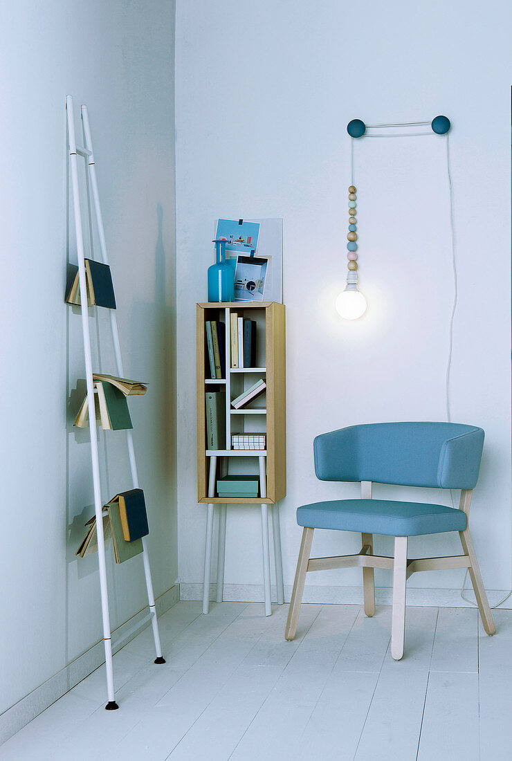 Books on shelves and ladder and DIY reading lamp in reading corner