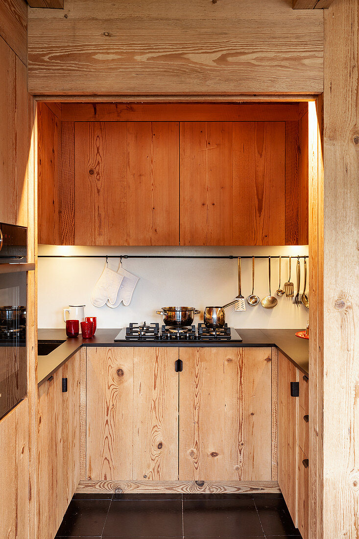 U-shaped fitted kitchen with wooden cupboards
