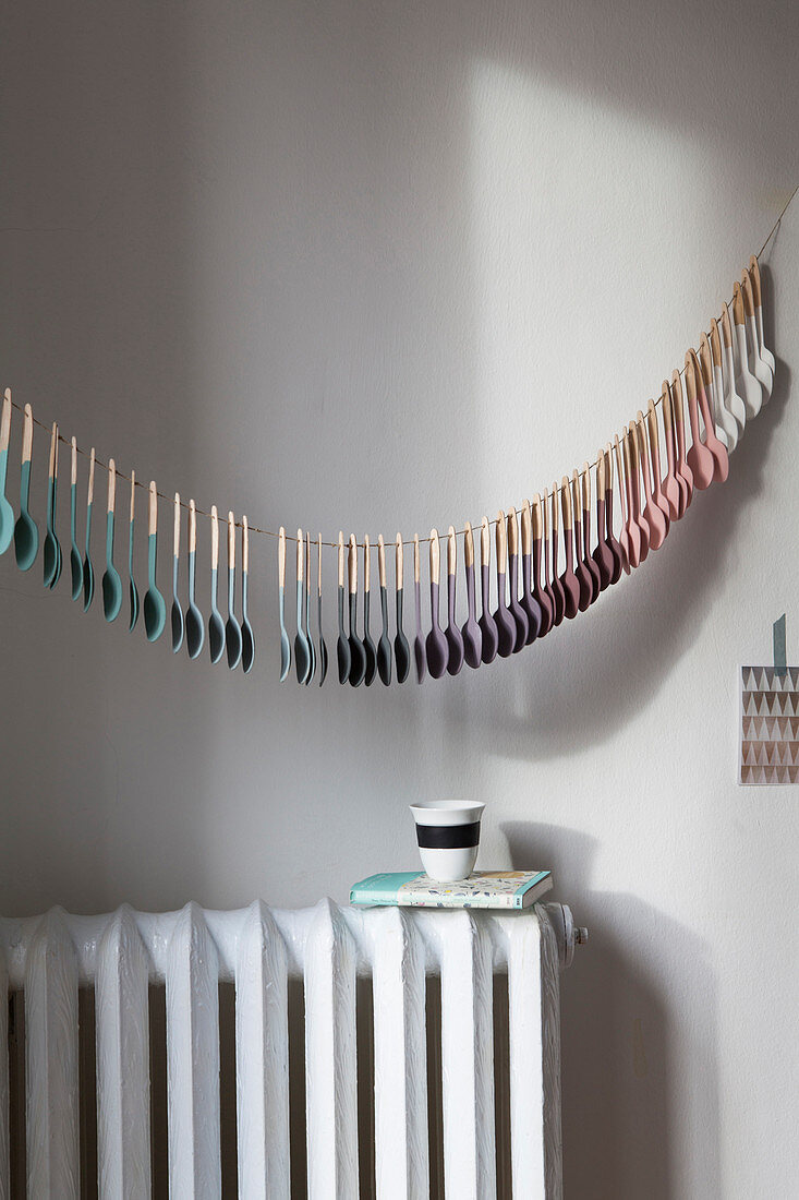 Garland of wooden spoons dipped in paint with colour gradient