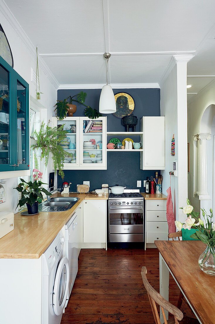 L-shaped country-house kitchen with dark blue end wall
