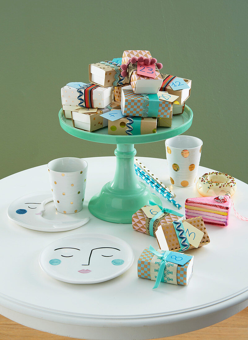Numbered gifts wrapped in colourful paper on cake stand