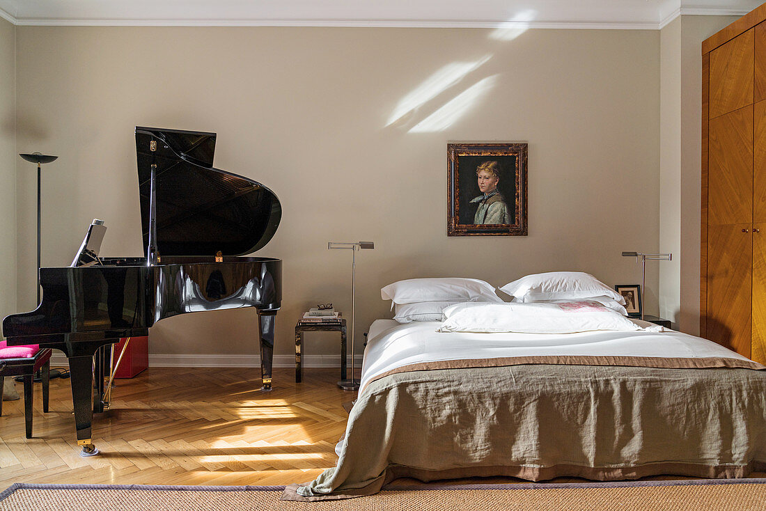 Double bed and grand piano in bedroom