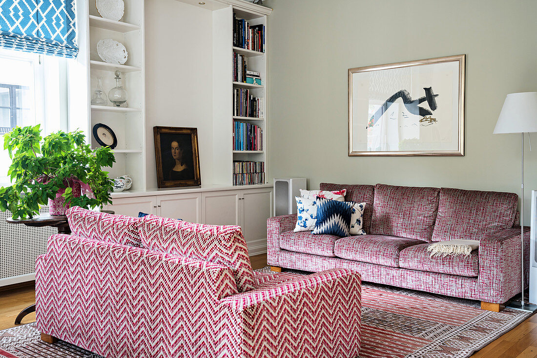 Pink sofas and white shelves in living room