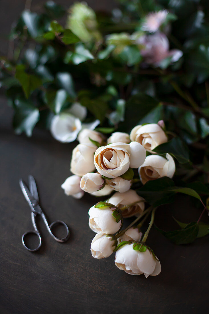 Apricot silk flowers and old pair of scissors