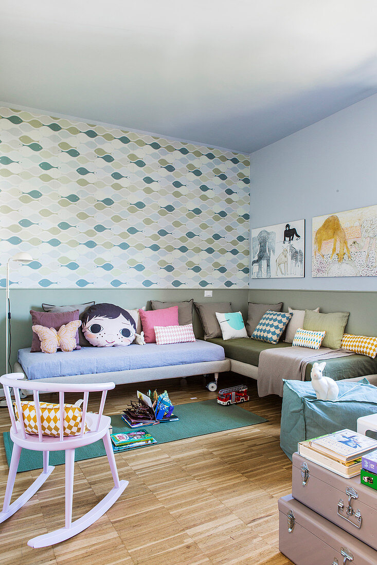 Twin beds arranged in L used as sofas in children's bedroom