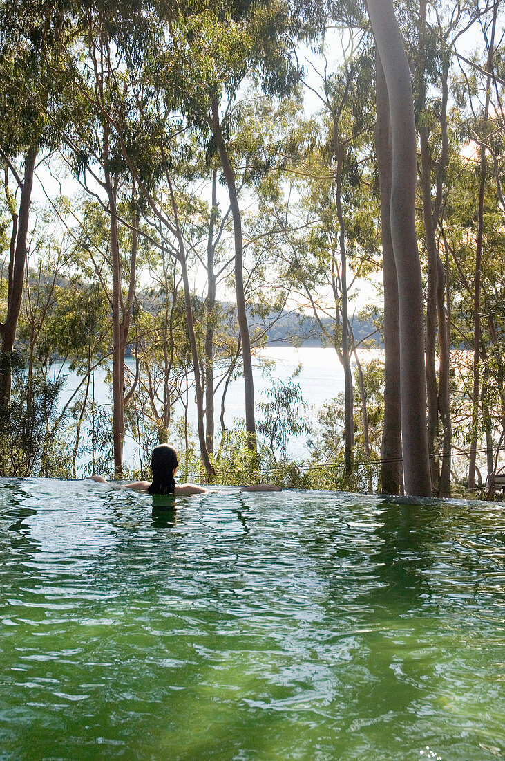 Infinity-Pool mit Blick auf Waldlandschaft und See