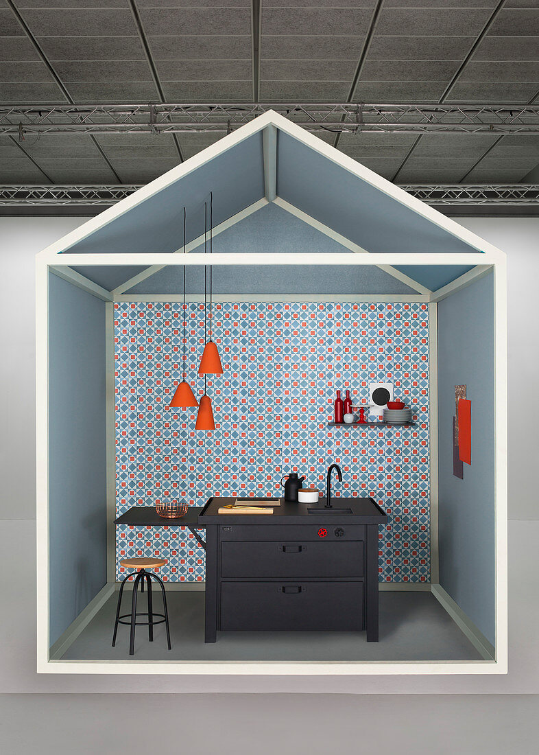 Creative idea for kitchen area with black sink unit against blue-and-red wallpaper