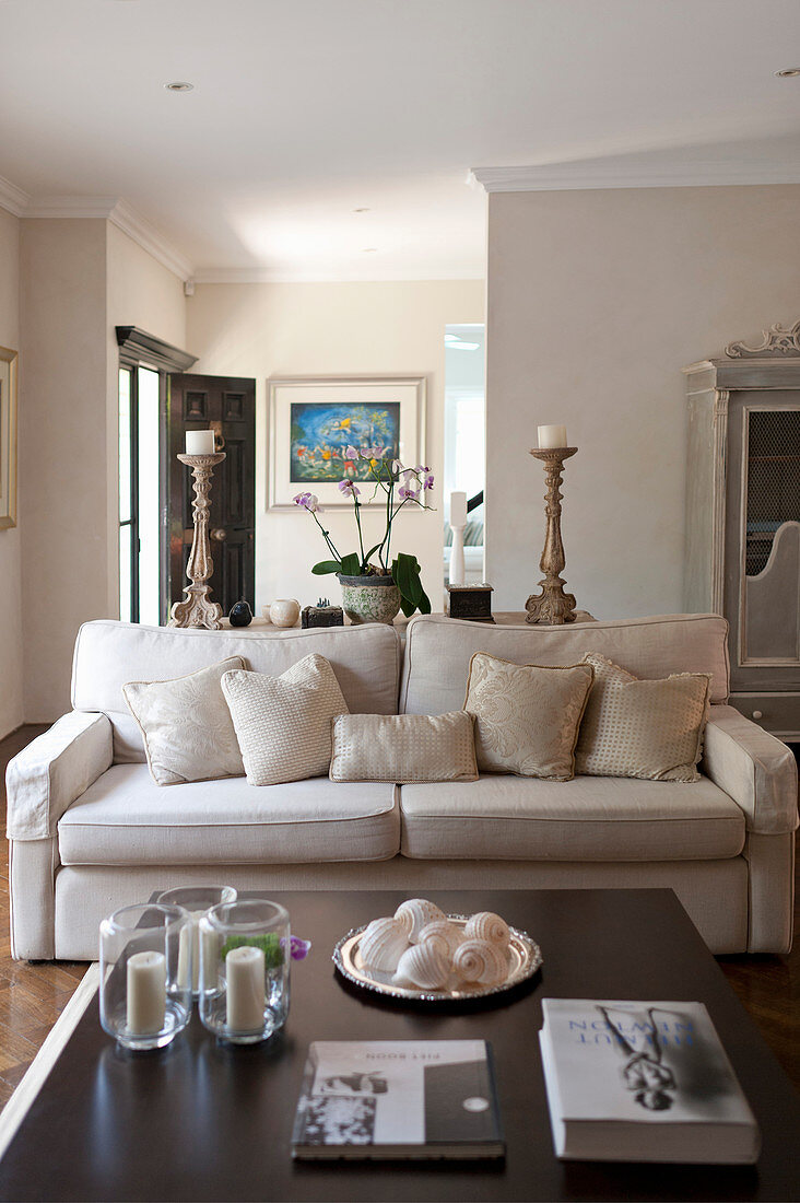 Coffee table and pale sofa with scatter cushions in living room