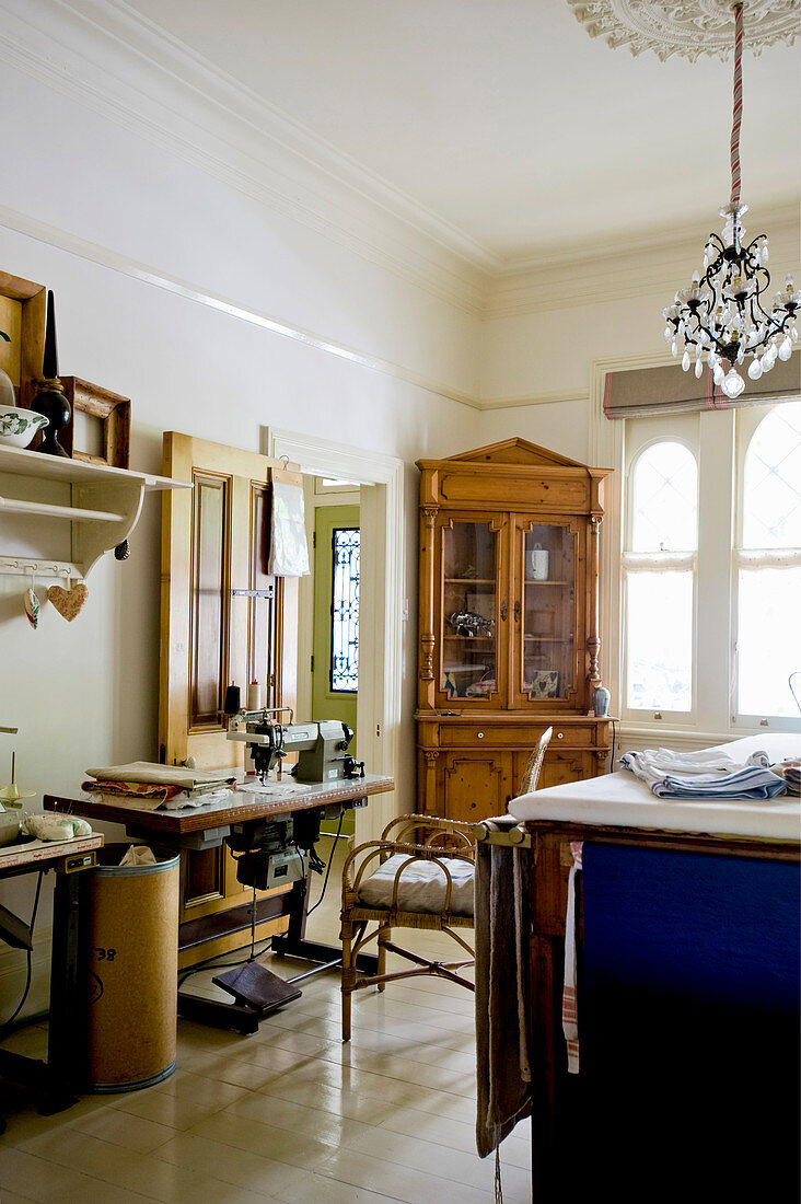 Antique corner cabinet and sewing machine in elegant room