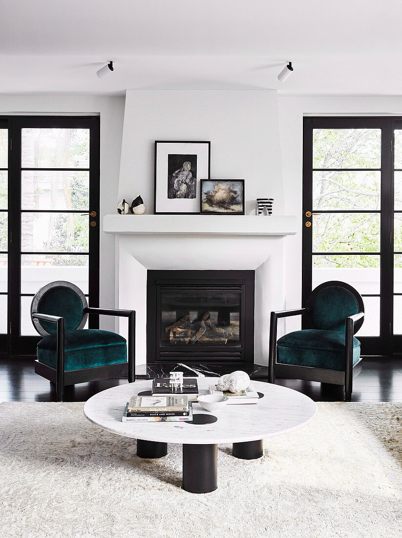 Low coffee table and two chairs in front of the fireplace in the living room