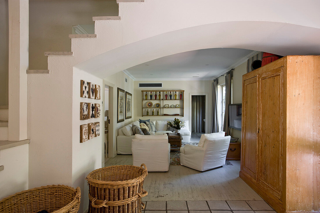 Wohnzimmer im Landhausstil mit niedriger Decke, Holzschrank und weißen Hussenmöbeln