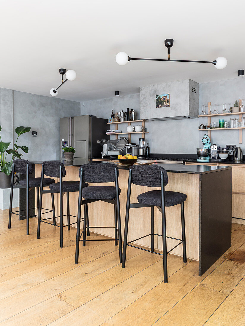 Open-plan kitchen with counter and barstools