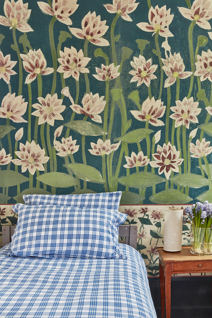 Water lilies painted on wall of vintage-style bedroom