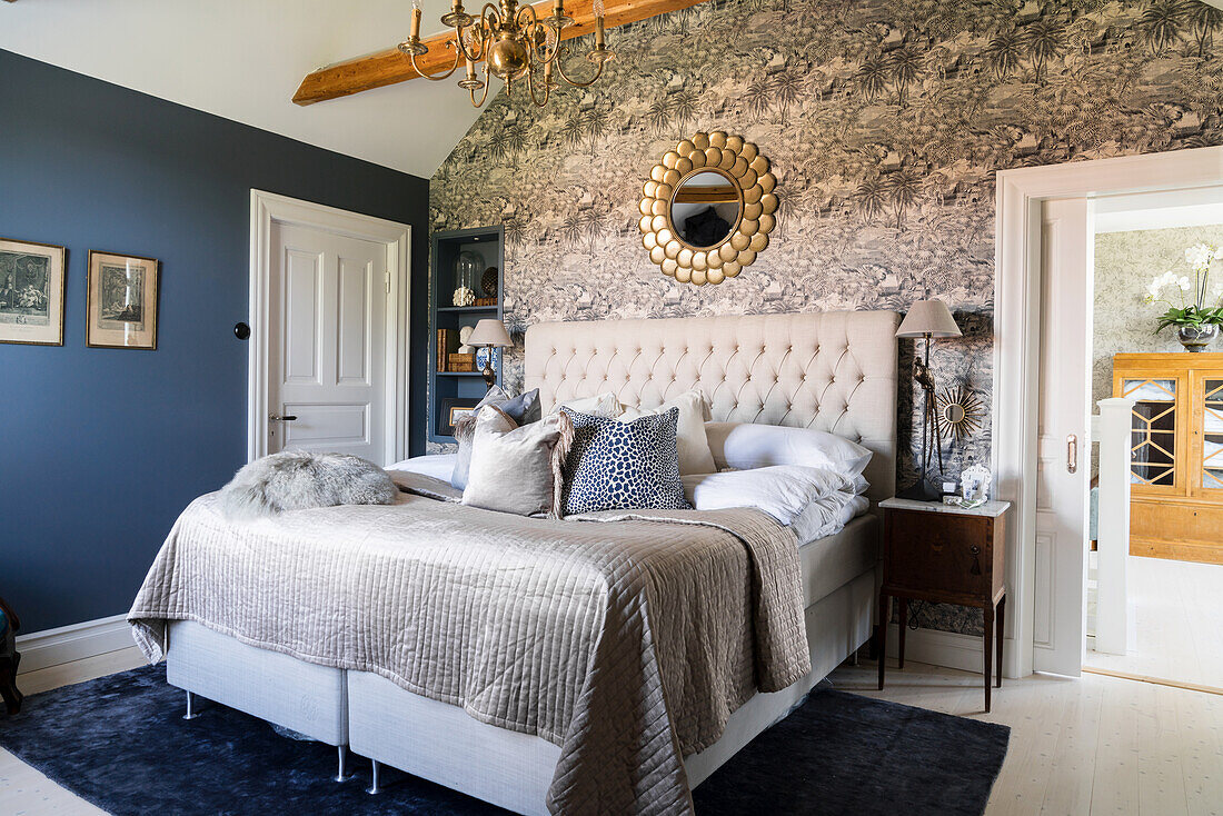 Double bed with button-tufted headboard in bedroom
