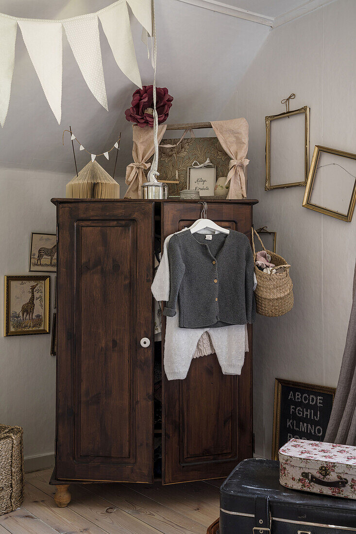 Old wardrobe and baby clothes in the nursery