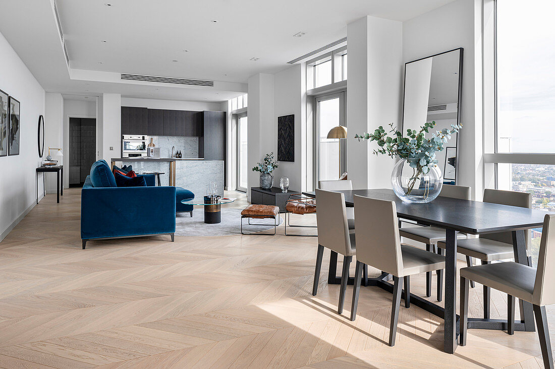 Modern open living room with herringbone parquet in a high-rise