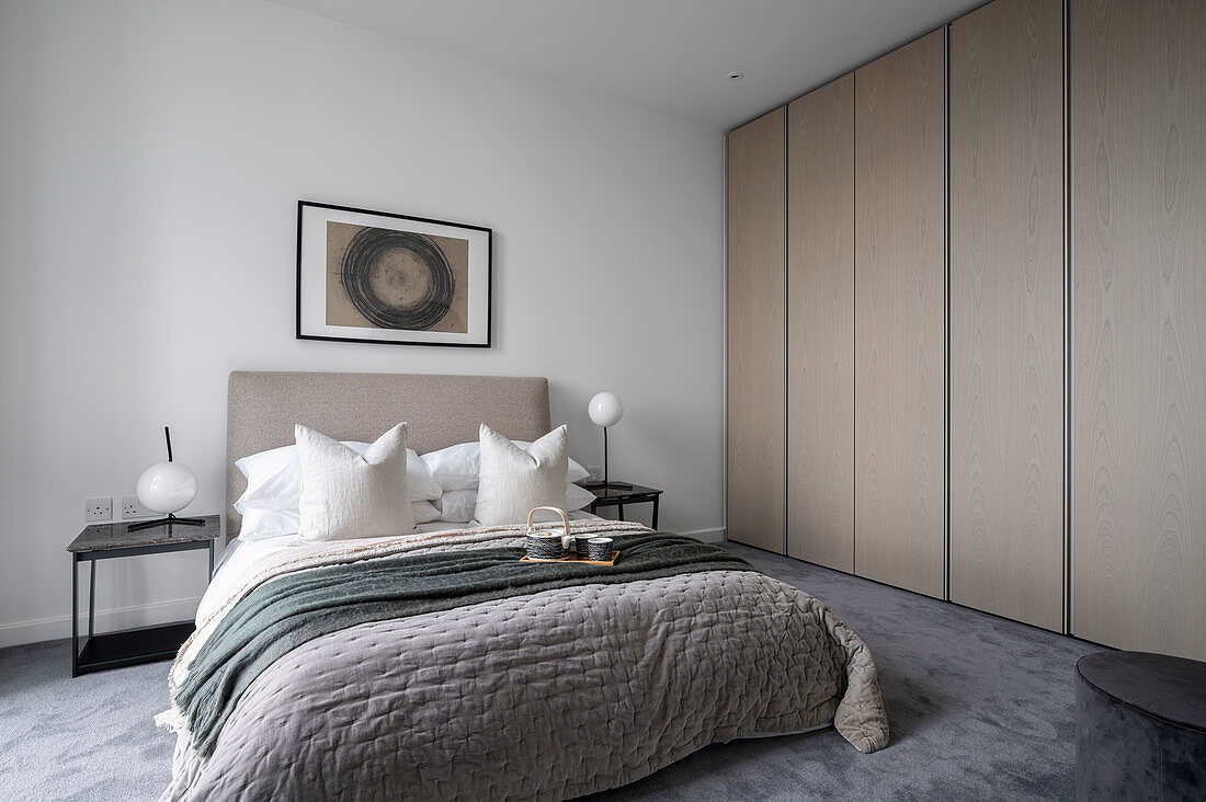 Modern bedroom in gray tones with a built-in wardrobe
