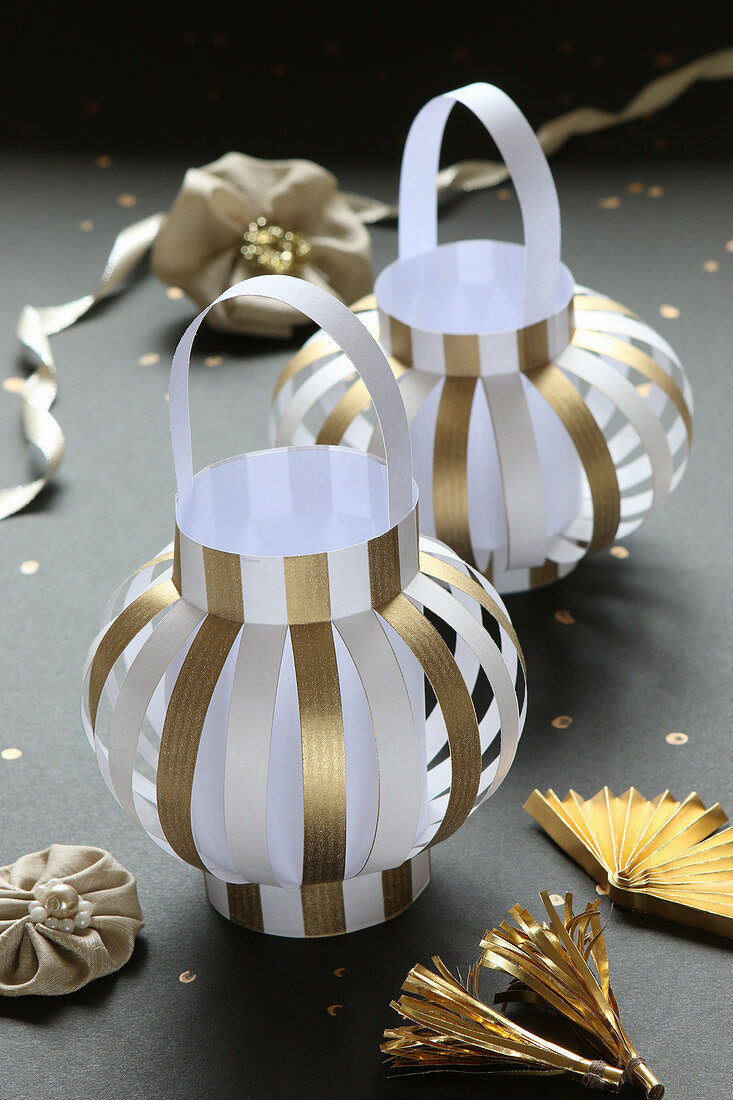 Lanterns handmade from gold and white striped paper