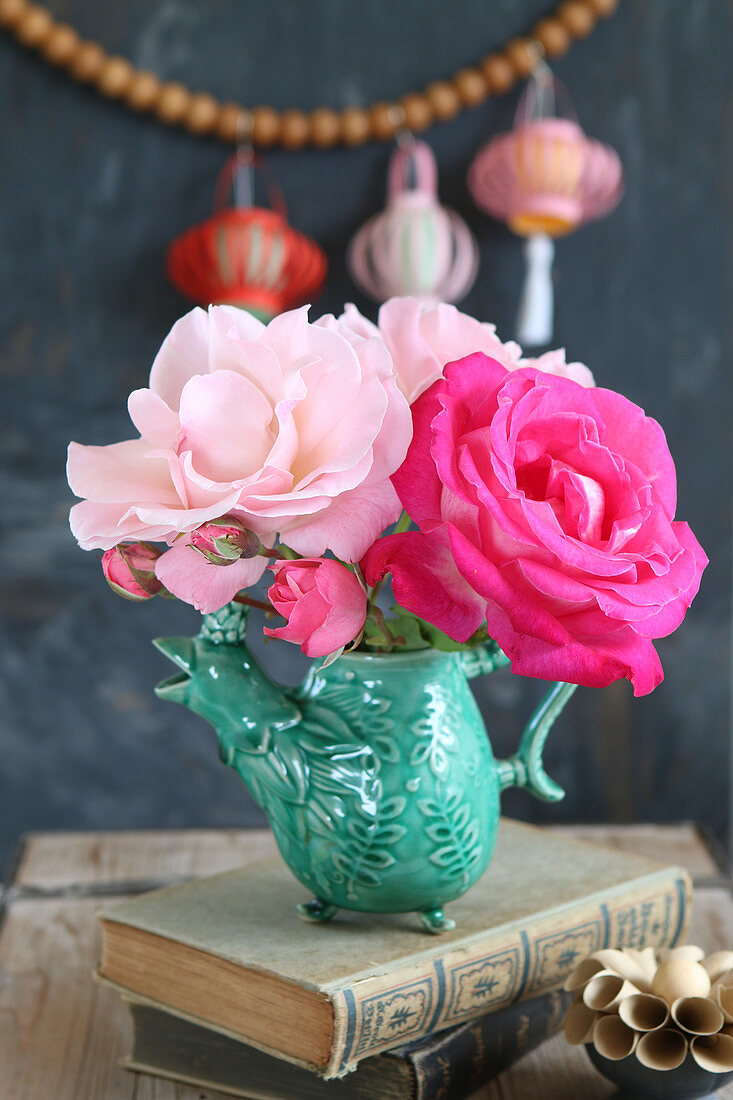 Pale and deep pink roses in bird-shaped vase