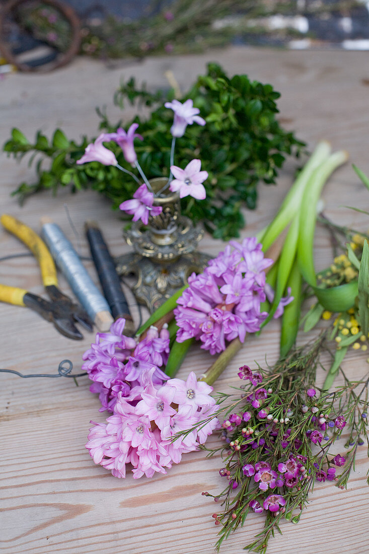 Materials for spring wreath: hyacinths, waxflowers, mimosa, box, florists' wire and wire cutters